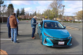 light blue electric car at finish